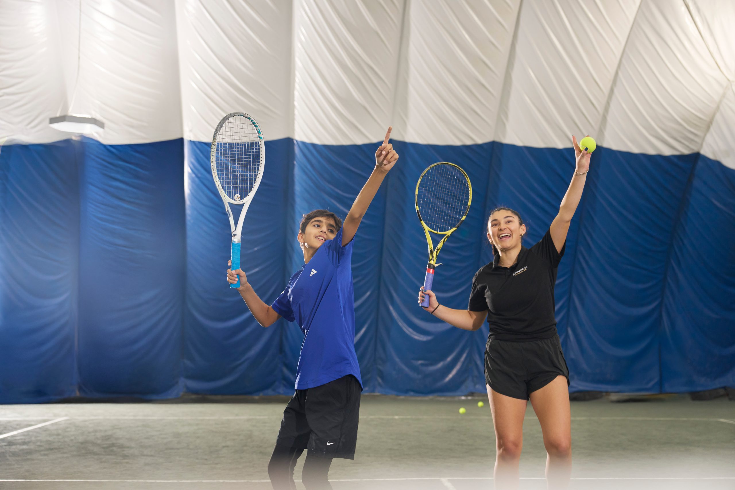 A boy swimming with foam pool noodles at one of ATC's summer day camps in New York City.