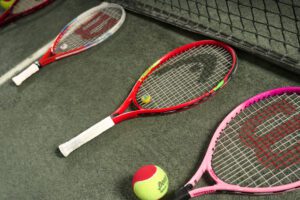 Various Wilson racquets on a racquet sport court.